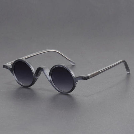 Anteojos de sol retro Warhol con armazón de acetato negro, lentes redondos oscuros, estilo arte pop para jóvenes urbanos.