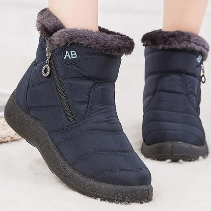 Bota impermeable azul marino con forro de felpa para mujeres, diseño elegante y moderno ideal para invierno.
