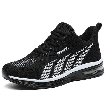 Zapatilla deportiva transpirable negra con detalles blancos, suela ergonómica anti-impacto, unisex, ideal para actividad diaria.