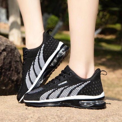 Zapatillas deportivas transpirables negras y blancas para adultos, con suela ergonómica y diseño anti-impacto.