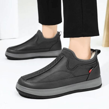 Zapatilla de invierno para adultos, color negro, material transpirable y elástico, ideal para calidez y confort.