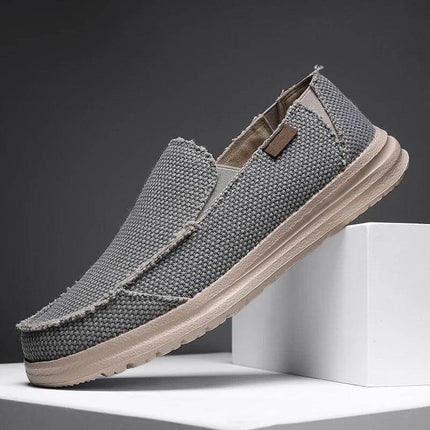 Zapato informal transpirable de lona gris para hombre, diseño cómodo y versátil, ideal para uso diario.